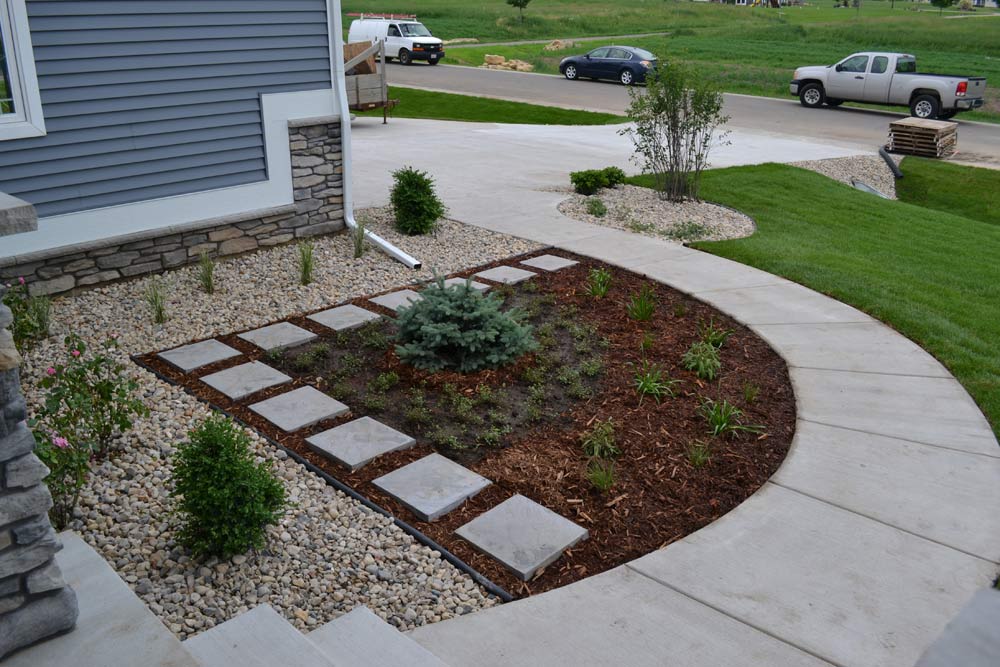 Interesting walkway and garden bed with stones instead of mulch